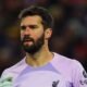 Did VAR swindle Manchester City? Controversially, Ruben Dias's goal is ruled out due to a foul on the Liverpool goalkeeper, and Alisson is relieved after fumbling the ball.