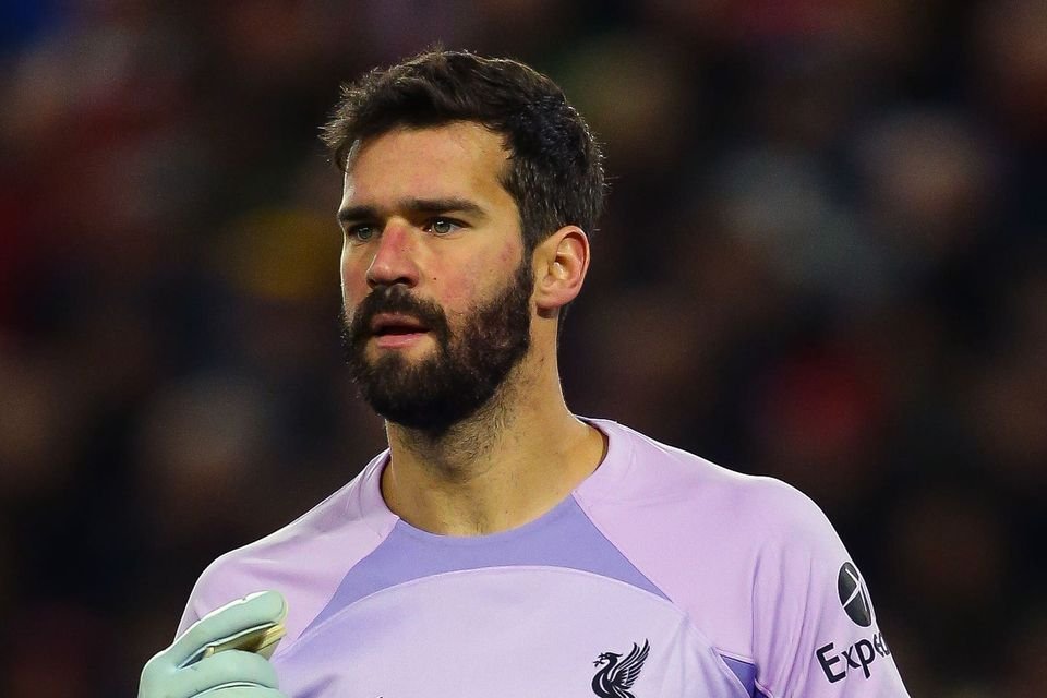 Did VAR swindle Manchester City? Controversially, Ruben Dias's goal is ruled out due to a foul on the Liverpool goalkeeper, and Alisson is relieved after fumbling the ball.